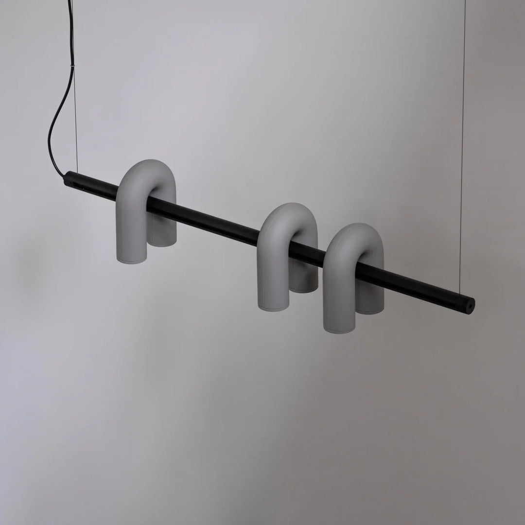 Lampa wisząca z cylindrycznymi punktami świetlnymi na łukowatych ramionach