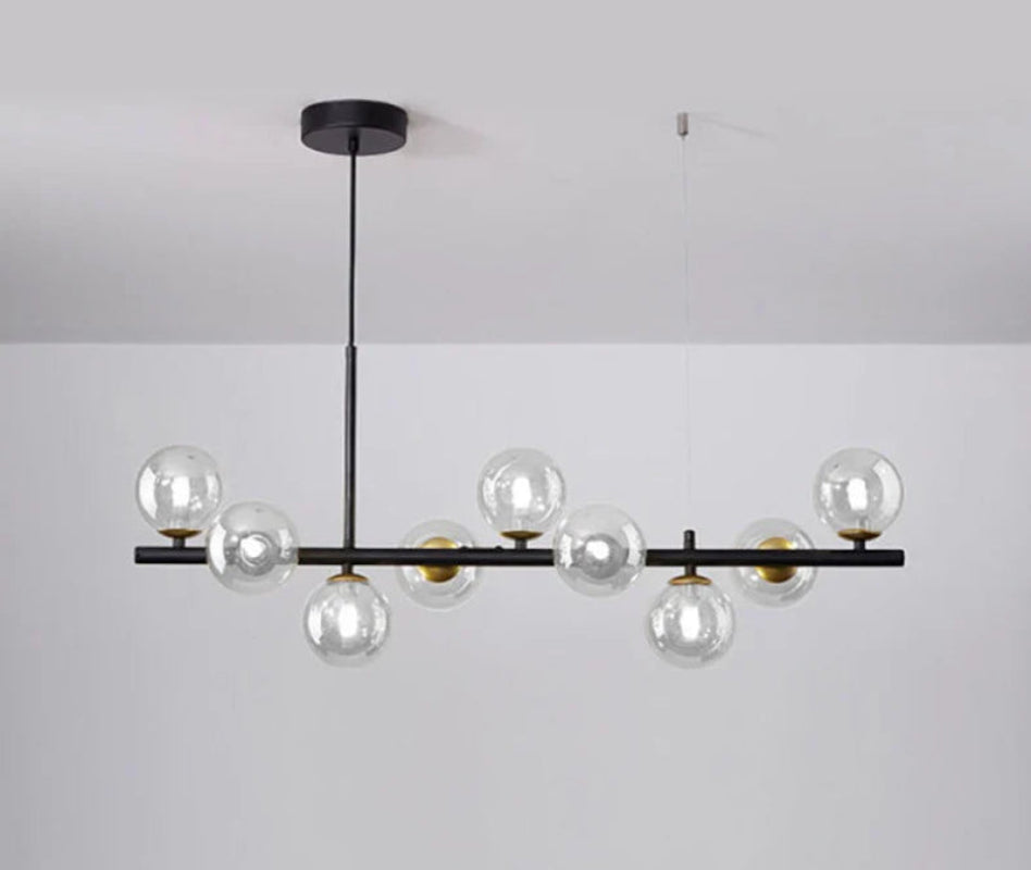 Lampa wisząca z poziomym ramieniem i kulistymi szklanymi kloszami